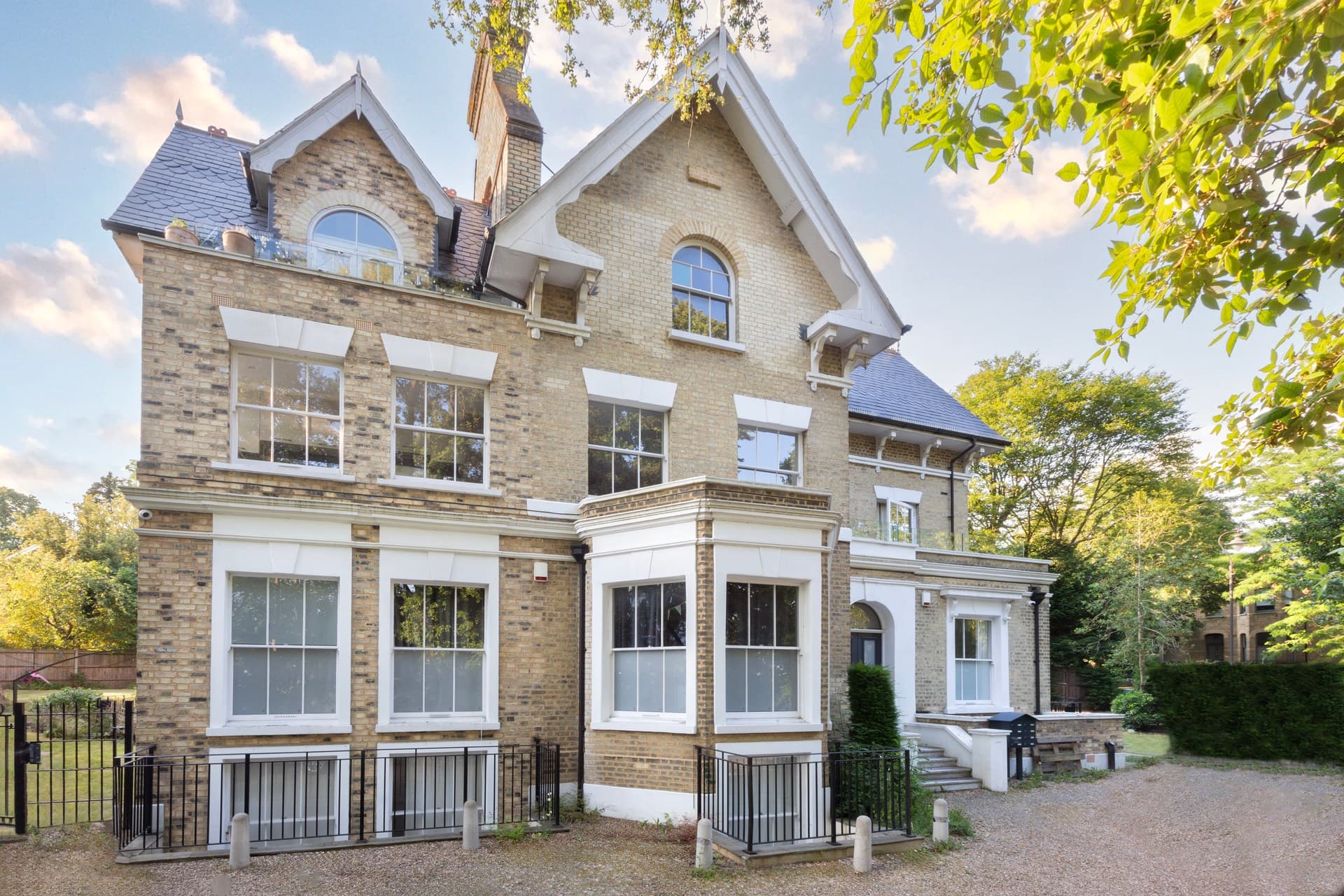 51 Fox Hill, a restored Victorian Gothic villa shown from the garden elevation in late afternoon light.